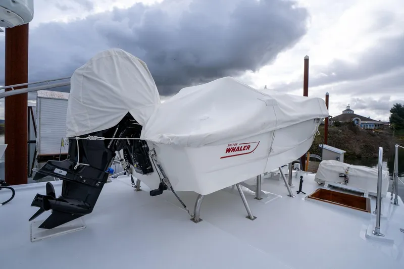 Slide: The Image of Covered Boston Whaler on 1965 De Vries Lentsch 64 Motoryacht deck under cloudy sky. - 78