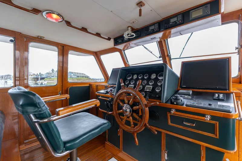 Slide: The Image of Vintage 1965 De Vries Lentsch 64 Motoryacht helm with classic wooden steering wheel. - 8