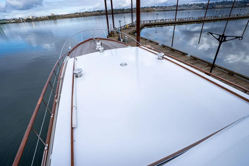 Slide: The Image of De Vries Lentsch 64 Motoryacht 1965, docked with scenic waterfront view. - 80