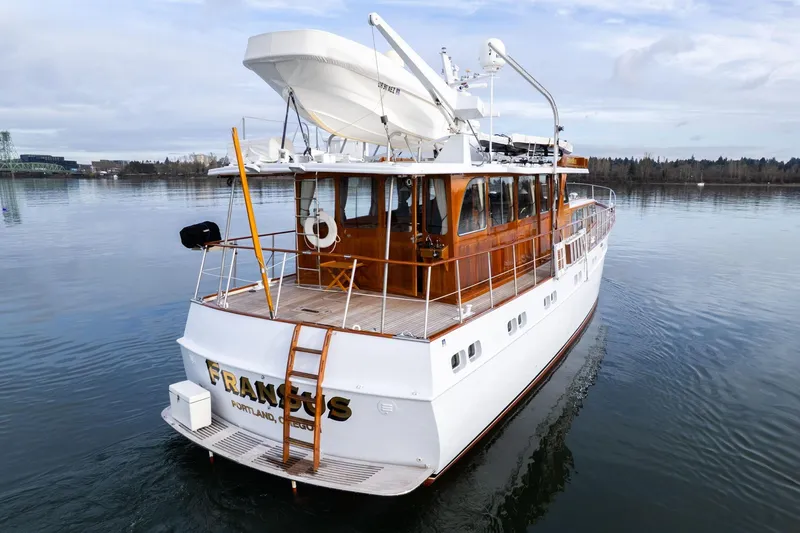 Slide: The Image of Classic 1965 De Vries Lentsch 64 Motoryacht on calm water, featuring elegant wooden details. - 87