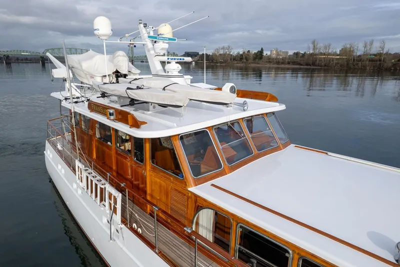 Slide: The Image of 1965 De Vries Lentsch 64 Motoryacht on calm water, showcasing elegant wooden design. - 90
