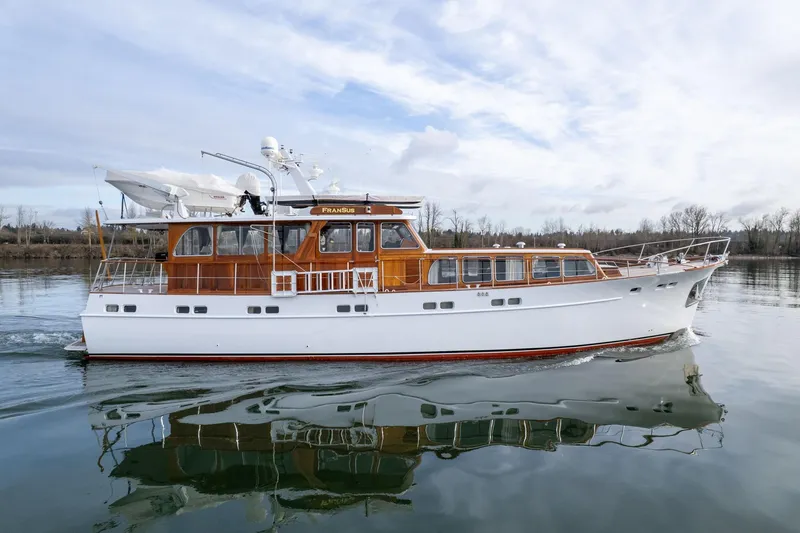 Slide: The Image of 1965 De Vries Lentsch 64 Motoryacht cruising on calm waters under a cloudy sky. - 92