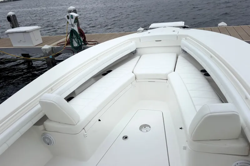 Slide: The Image of 2017 Regulator 28 boat interior with white seating, docked by the water. - 14