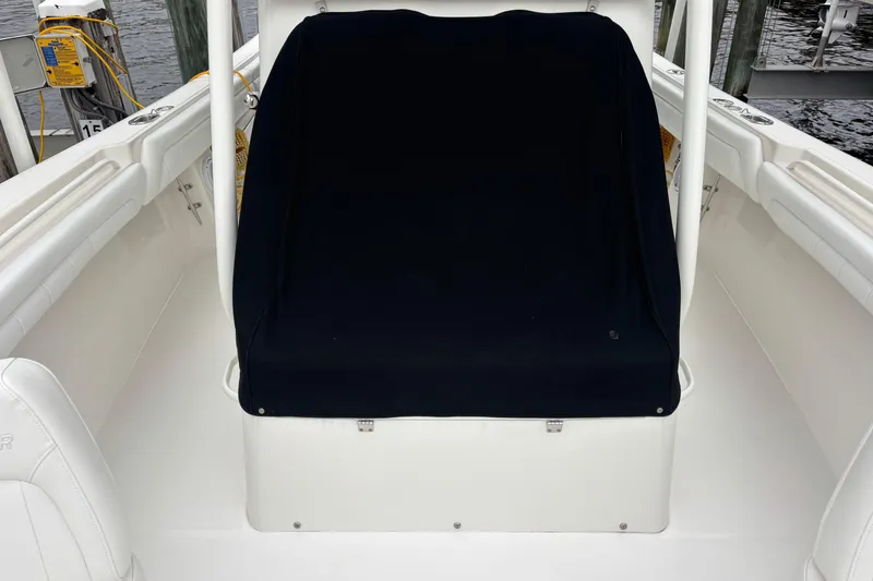 Slide: The Image of 2017 Regulator 28 boat interior with covered seating area at dock. - 16