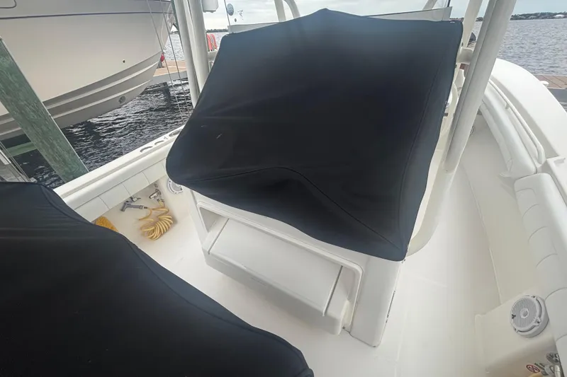 Slide: The Image of 2017 Regulator 28 boat interior with covered seating and dock view. - 20