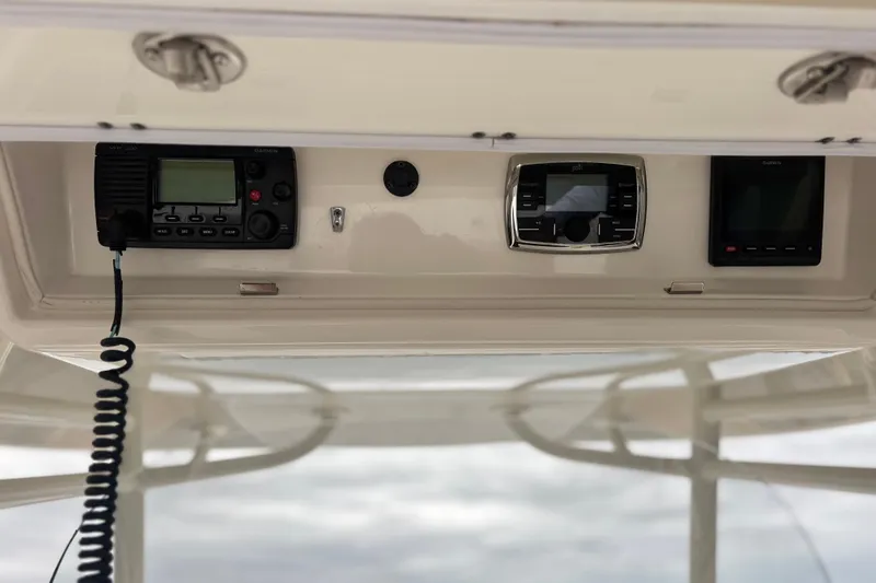 Slide: The Image of 2017 Regulator 28 boat dashboard with Garmin VHF radio and Polk audio system. - 25