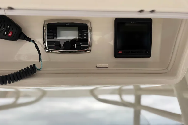 Slide: The Image of 2017 Regulator 28 boat dashboard with Polk audio system and Garmin display. - 27