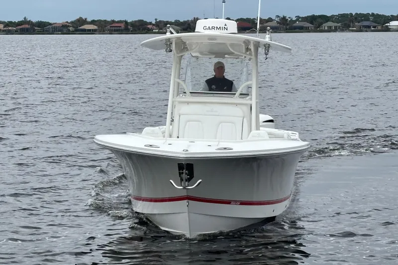 Slide: The Image of 2017 Regulator 28 boat cruising on a calm lake with a visible Garmin device. - 3