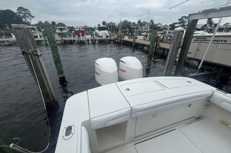 Slide: The Image of 2017 Regulator 28 boat docked with twin Yamaha engines in a marina. - 37