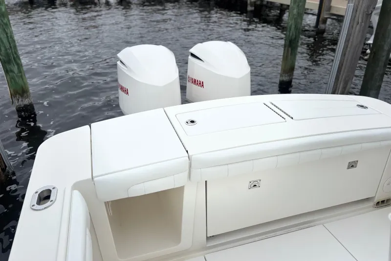 Slide: The Image of 2017 Regulator 28 boat with Yamaha outboard engines docked by the water. - 38