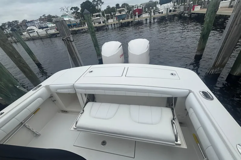 Slide: The Image of 2017 Regulator 28 boat with white seating and dual engines docked at marina. - 39