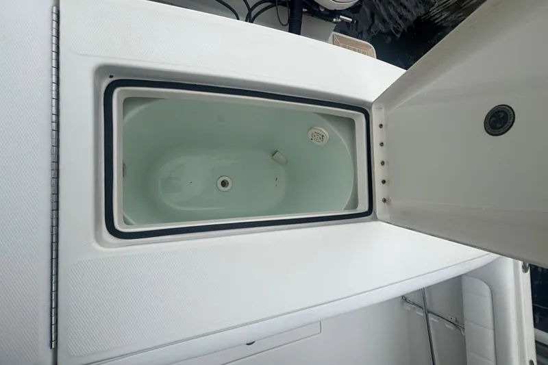 Slide: The Image of Open storage compartment on a 2017 Regulator 28 boat, showcasing interior details. - 40