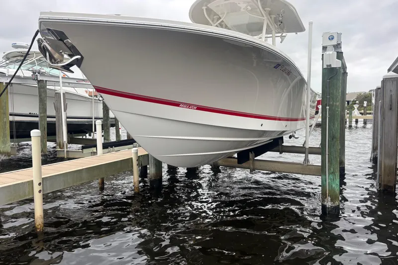 Slide: The Image of 2017 Regulator 28 boat on lift at marina dockside. - 45