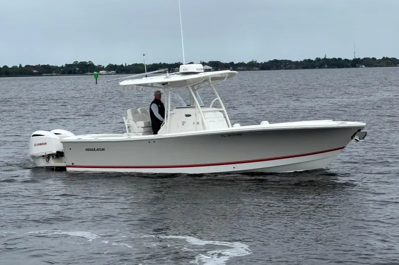 Slide: The Image of 2017 Regulator 28 boat with Yamaha engines on calm water. - 5