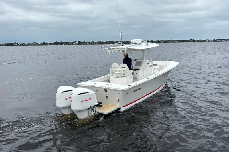 Slide: The Image of 2017 Regulator 28 boat with twin Yamaha engines cruising on open water. - 7