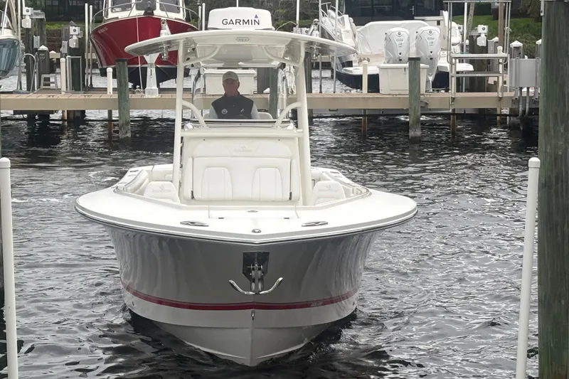 Slide: The Image of 2017 Regulator 28 boat docked, featuring Garmin equipment, in a marina setting. - 8