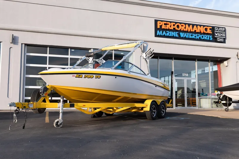 The Image of 2005 MasterCraft X10 boat on trailer outside Performance Marine Watersports store. - 0