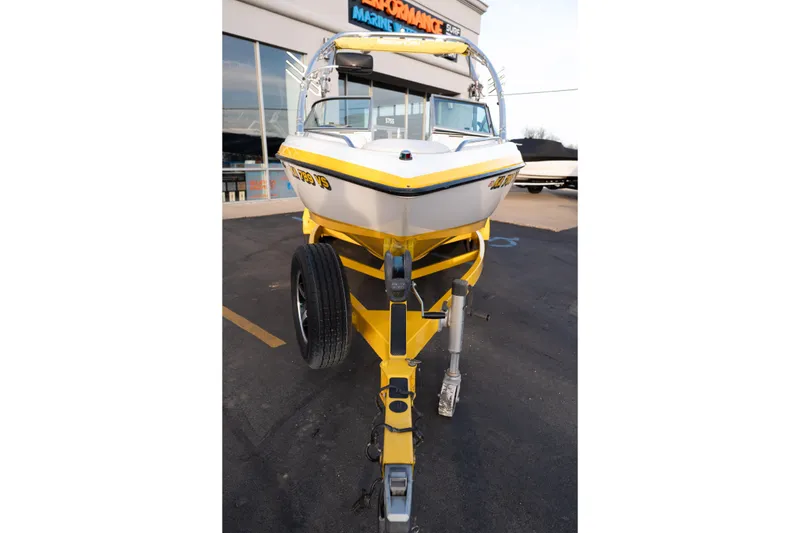 Slide: The Image of 2005 MasterCraft X10 boat on yellow trailer in parking lot. - 10