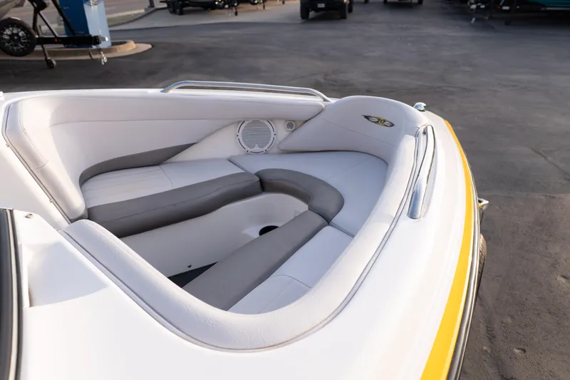 Slide: The Image of 2005 MasterCraft X10 boat interior with white and gray seating, outdoor setting. - 11