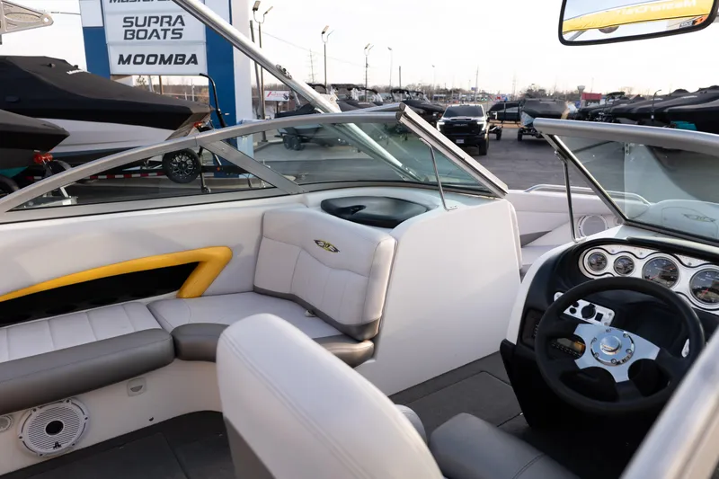 Slide: The Image of 2005 MasterCraft X10 boat interior with steering wheel and seating, displayed at a dealership. - 12
