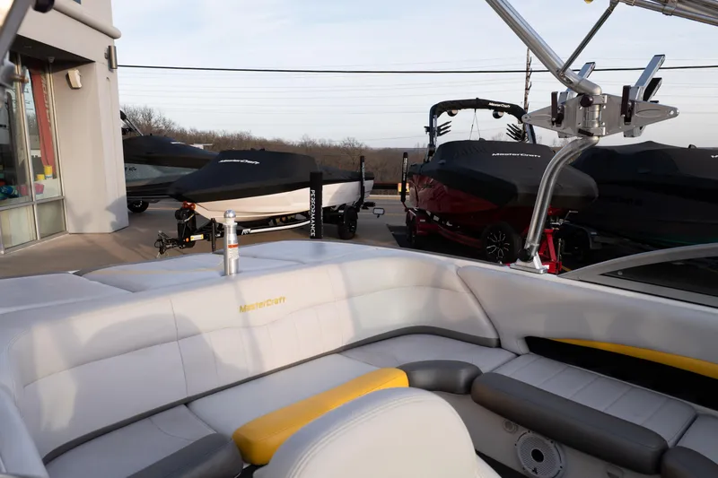 Slide: The Image of 2005 MasterCraft X10 boat interior with covered boats in the background. - 13