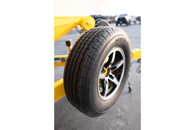 Slide: The Image of Close-up of a 2005 MasterCraft X10 trailer tire with black alloy wheel. - 16