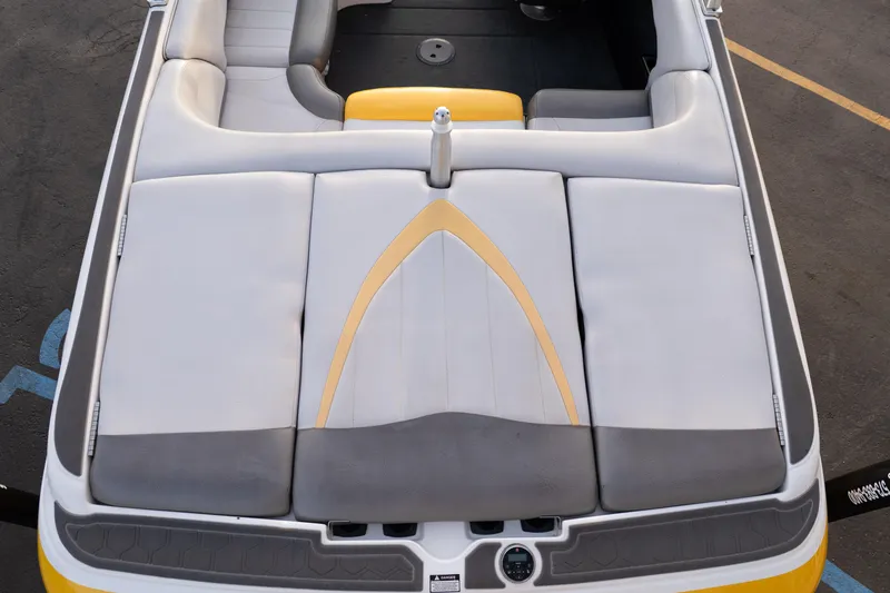 Slide: The Image of 2005 MasterCraft X10 boat interior with gray and yellow upholstery. - 19