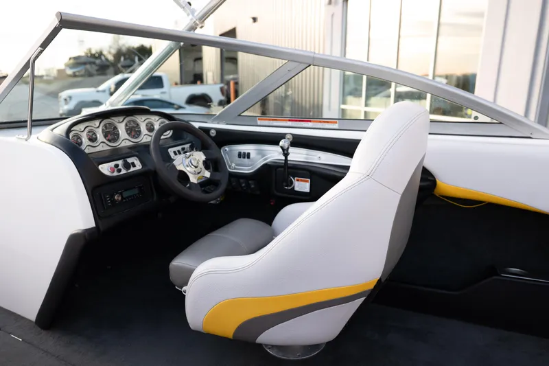 Slide: The Image of Interior of a 2005 MasterCraft X10 boat, featuring steering wheel and dashboard controls. - 24