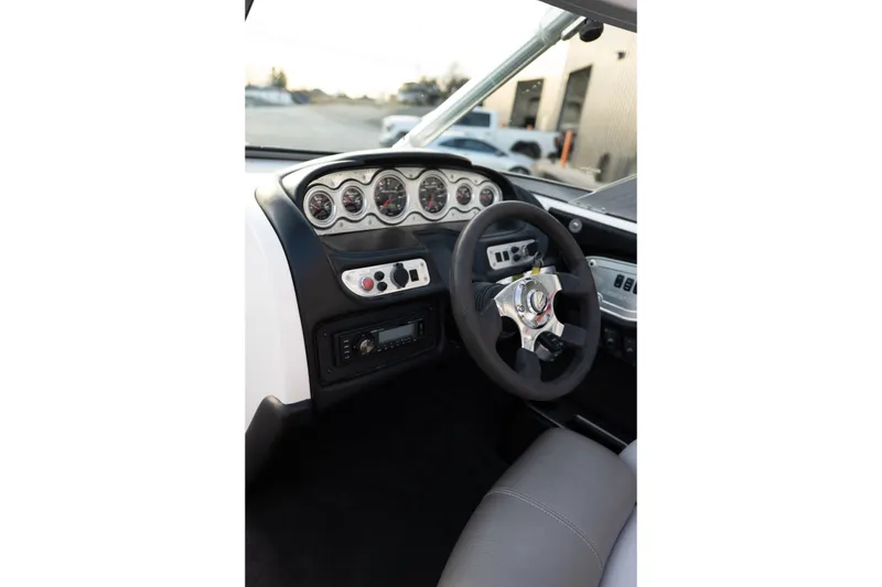 Slide: The Image of 2005 MasterCraft X10 boat dashboard with steering wheel and instrument panel. - 26