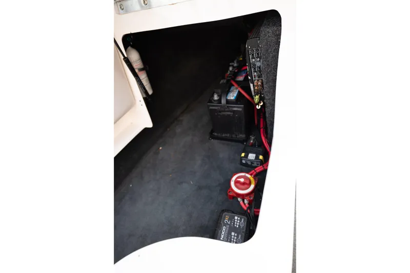 Slide: The Image of 2005 MasterCraft X10 boat interior showing battery compartment and wiring setup. - 28