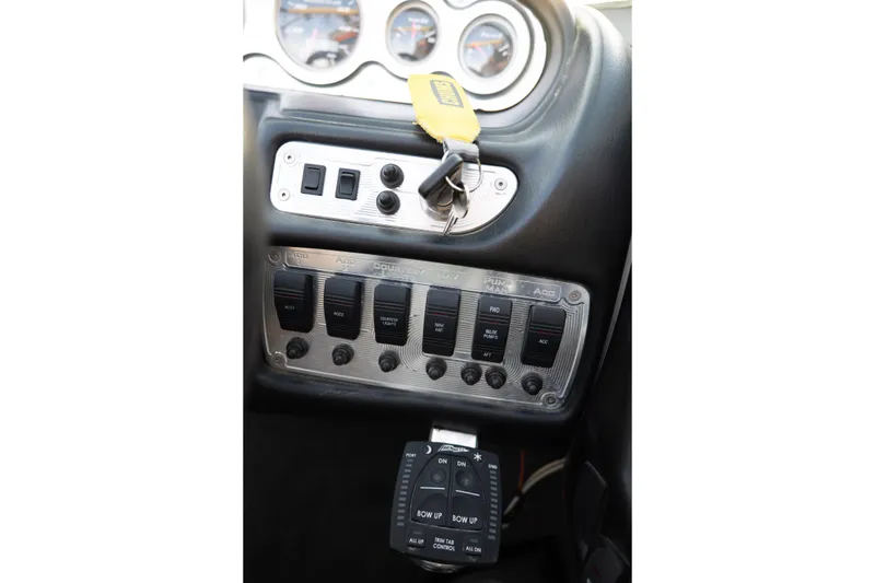 Slide: The Image of Control panel of a 2005 MasterCraft X10 boat with switches and key. - 30