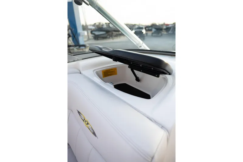Slide: The Image of 2005 MasterCraft X10 boat interior with open storage compartment and white upholstery. - 33