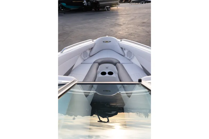 Slide: The Image of 2005 MasterCraft X10 boat interior with white seating and cup holders. - 34