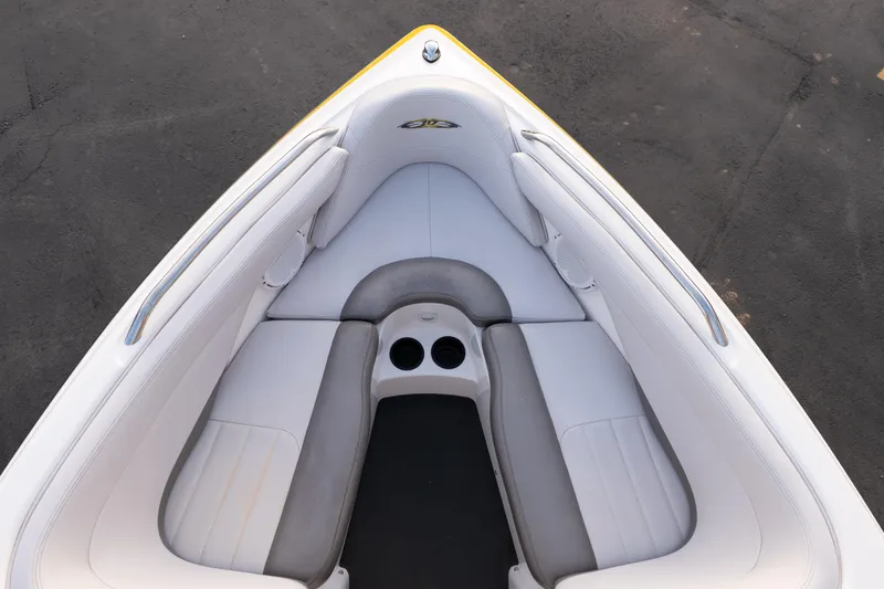 Slide: The Image of 2005 MasterCraft X10 boat interior with white and gray seating, cup holders, and sleek design. - 36