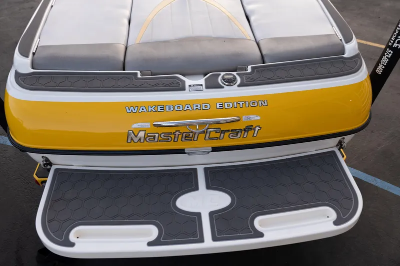 Slide: The Image of 2005 MasterCraft X10 Wakeboard Edition boat, yellow and gray rear view. - 47