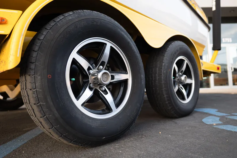 Slide: The Image of Close-up of 2005 MasterCraft X10 trailer wheels on pavement. - 49