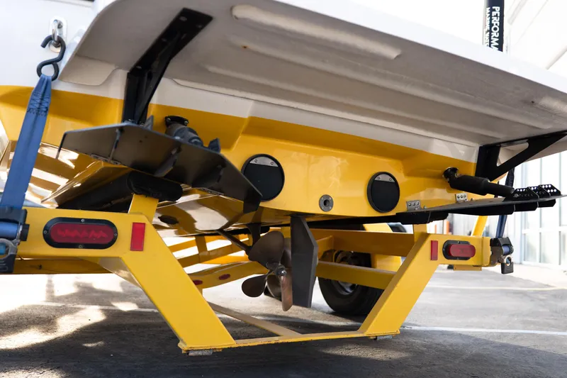 Slide: The Image of Rear view of a 2005 MasterCraft X10 boat on a yellow trailer. - 5