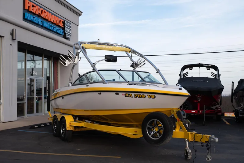 Slide: The Image of 2005 MasterCraft X10 boat with yellow accents parked at Performance Marine Watersports. - 51