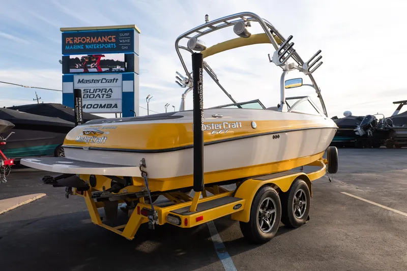 Slide: The Image of 2005 MasterCraft X10 boat in yellow on trailer at marine dealership. - 7