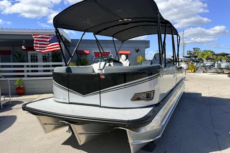 Slide: The Image of 2026 Avalon 2385 LSZ Versatile Rear Bench Tri Toon boat displayed outdoors. - 3