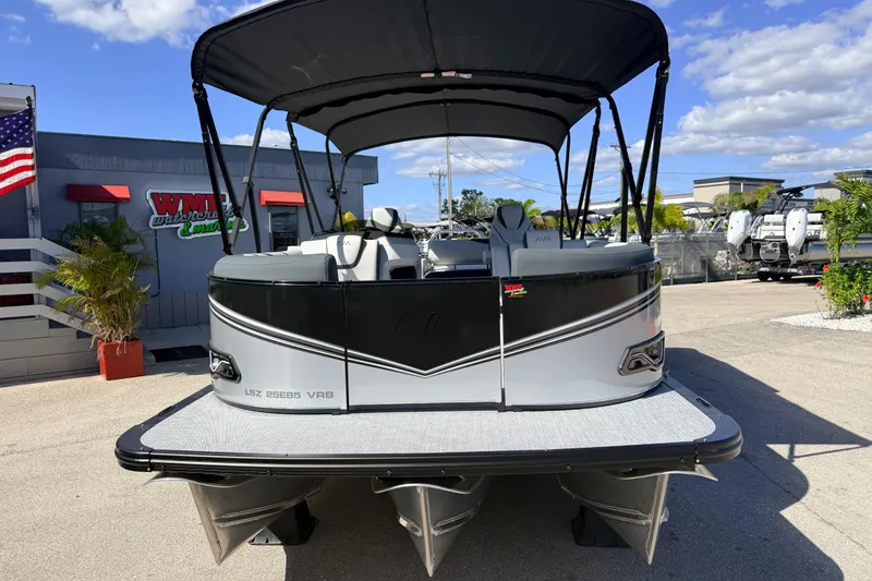 Slide: The Image of 2026 Avalon 2385 LSZ Versatile Rear Bench Tri Toon boat displayed outdoors. - 4