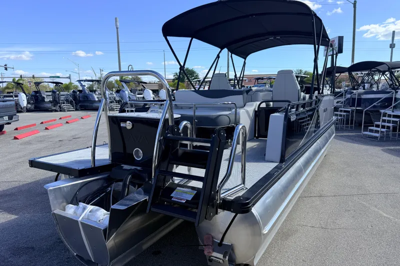Slide: The Image of 2026 Avalon 2385 LSZ Versatile Rear Bench Tri Toon boat displayed outdoors. - 7