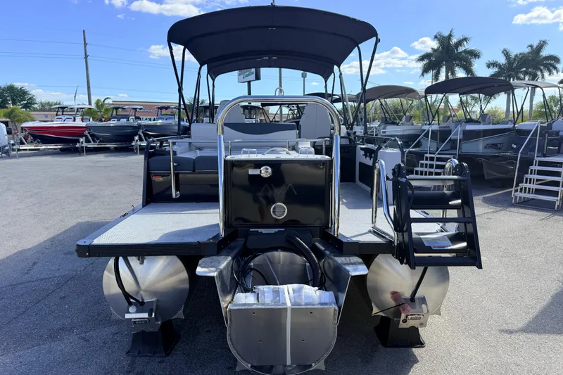 Slide: The Image of 2026 Avalon 2385 LSZ Versatile Rear Bench Tri Toon boat, rear view in sunny marina. - 8