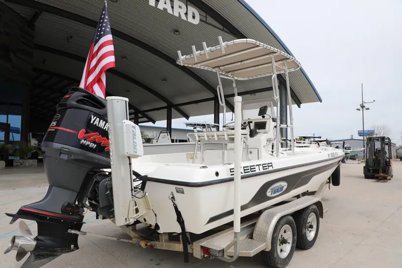 Slide: The Image of 2006 Skeeter ZX22 Bay T boat with Yamaha engine on trailer, American flag displayed. - 2