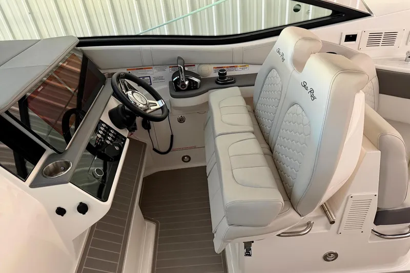 Slide: The Image of 2023 Sea Ray Sundancer 320 Coupe cockpit with dual seats and modern controls. - 15