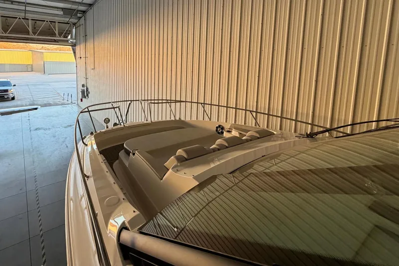 Slide: The Image of 2023 Sea Ray Sundancer 320 Coupe in a warehouse, showcasing sleek design and luxury features. - 7