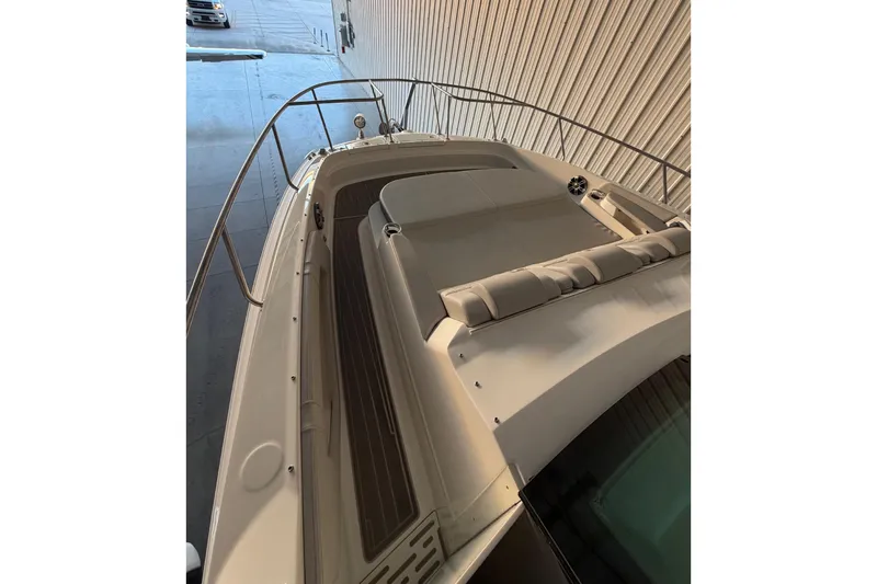 Slide: The Image of 2023 Sea Ray Sundancer 320 Coupe, sleek design, docked indoors, top deck view. - 8