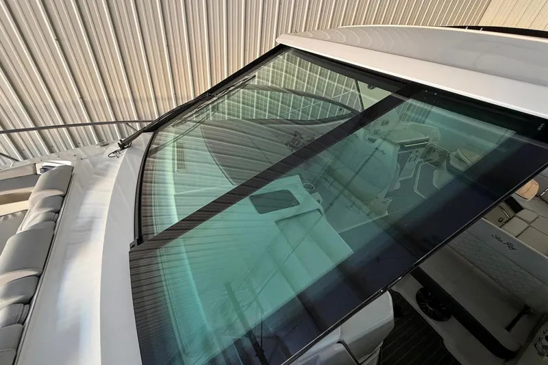 Slide: The Image of 2023 Sea Ray Sundancer 320 Coupe windshield and interior view in a covered dock. - 9