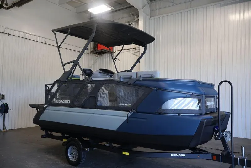 Slide: The Image of 2026 Sea-Doo Switch Cruise Limited 18 pontoon boat in a garage setting. - 30