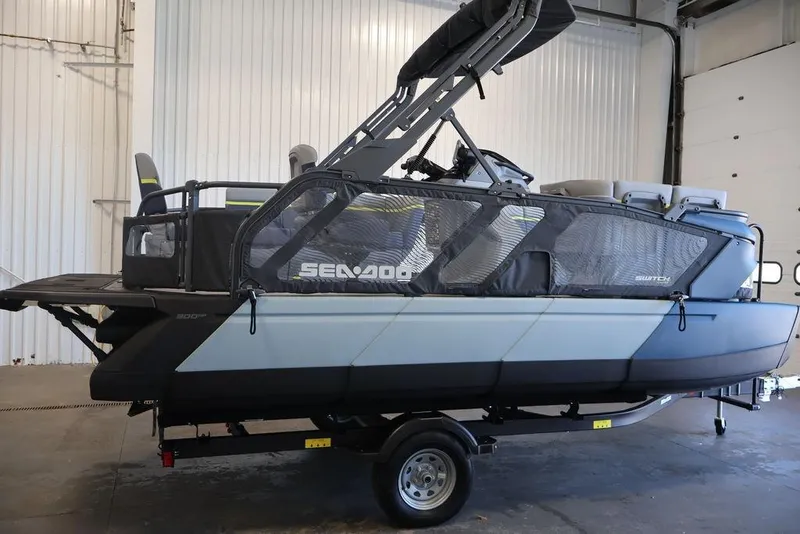 Slide: The Image of 2026 Sea-Doo Switch Cruise Limited 18 pontoon boat in a garage setting. - 6